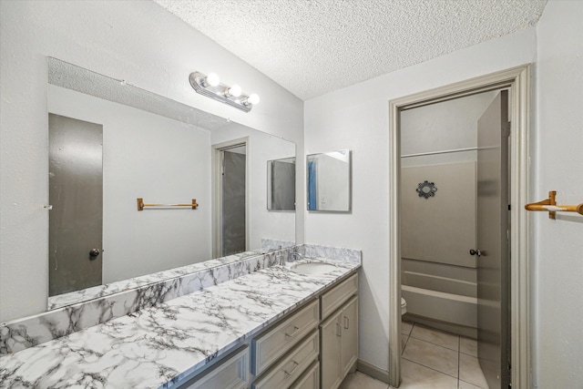 bathroom with tile patterned floors, vanity, toilet, and a textured ceiling