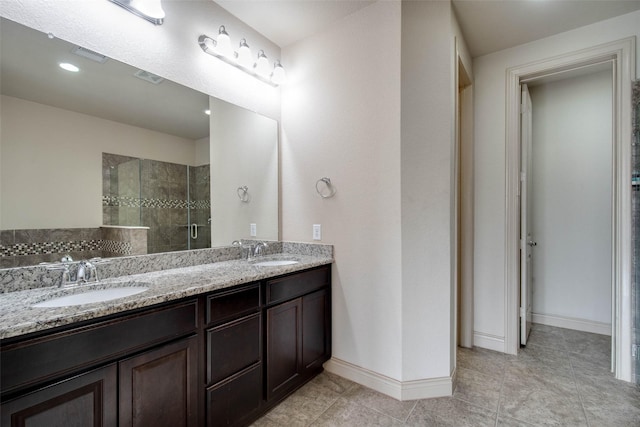 bathroom featuring vanity, tile patterned floors, and walk in shower