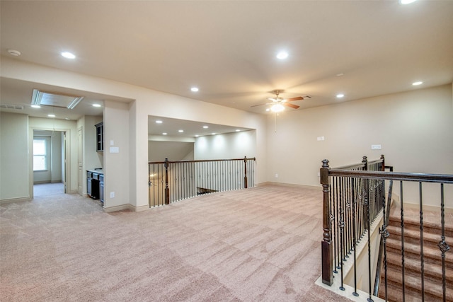 carpeted empty room featuring ceiling fan