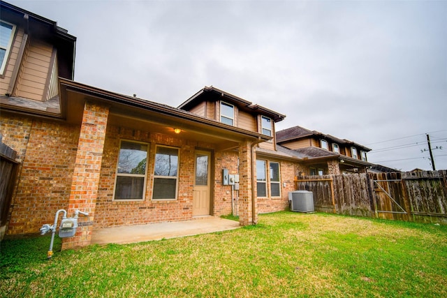 rear view of house featuring a yard, a patio area, and central air condition unit