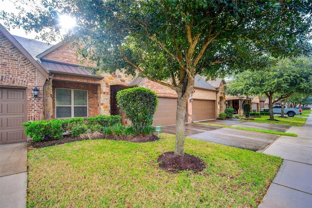 view of front of property featuring a garage and a front lawn