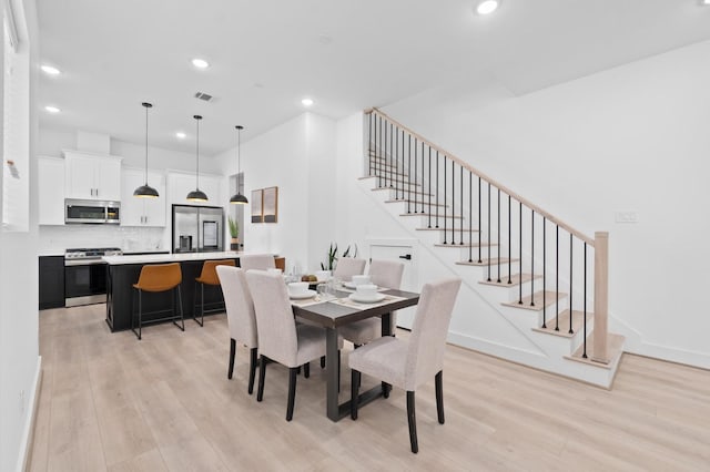 501 E 39th St, Houston, TX 77022 - dining area featuring light wood finished floors, stairs, and recessed lighting