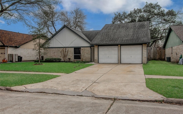 view of front of home with concrete driveway, roof with shingles, an attached garage, a front lawn, and brick siding