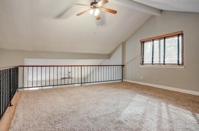 additional living space with carpet floors, baseboards, lofted ceiling with beams, a textured ceiling, and ceiling fan