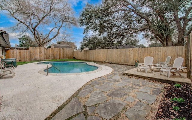 view of pool with a fenced in pool, a patio area, a fenced backyard, and a deck