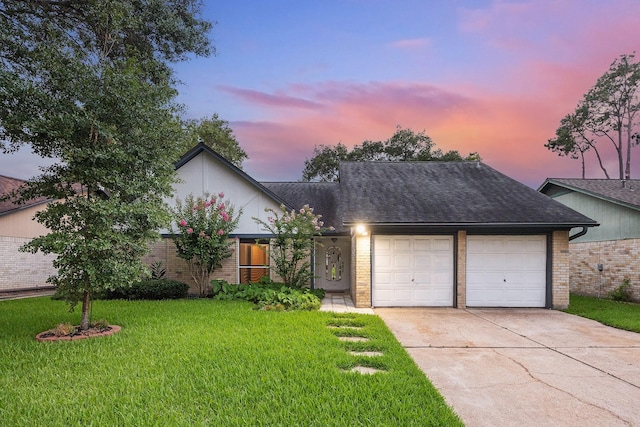 22403 Elsinore Dr, Katy, TX 77450 - view of front of home featuring brick siding, an attached garage, concrete driveway, and a yard