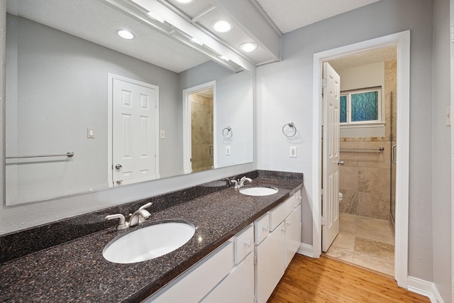 22403 Elsinore Dr, Katy, TX 77450 - full bath with double vanity, wood finished floors, and recessed lighting