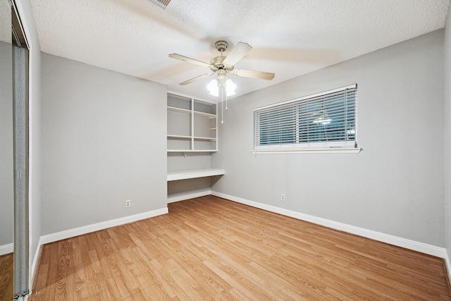 22403 Elsinore Dr, Katy, TX 77450 - spare room with wood finished floors, ceiling fan, and a textured ceiling