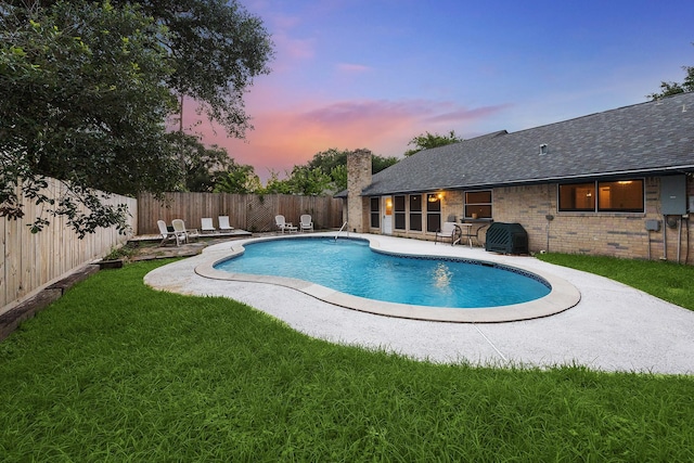 22403 Elsinore Dr, Katy, TX 77450 - pool at dusk featuring a patio and a fenced backyard
