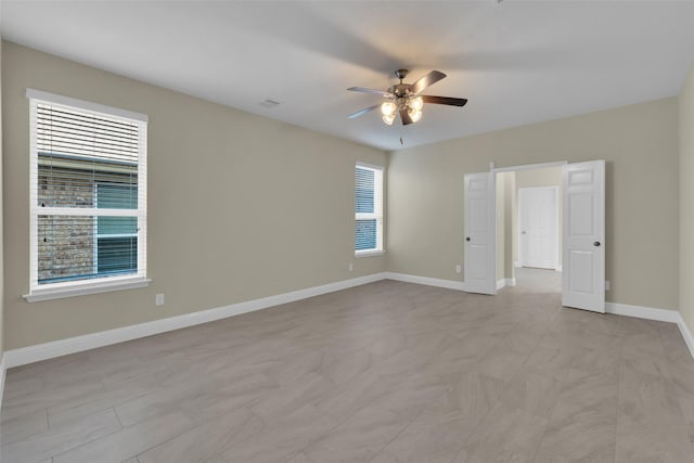 unfurnished room with ceiling fan