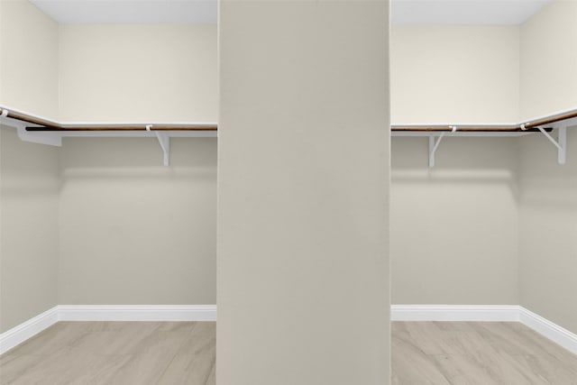 walk in closet featuring light hardwood / wood-style floors