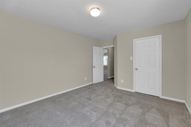 unfurnished bedroom featuring light carpet