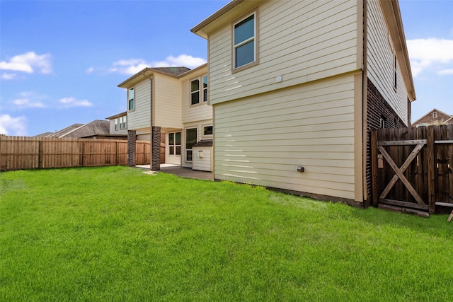 rear view of property featuring a yard and a patio