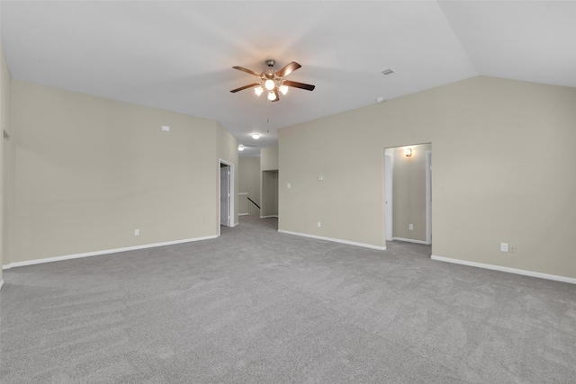 carpeted empty room with vaulted ceiling and ceiling fan