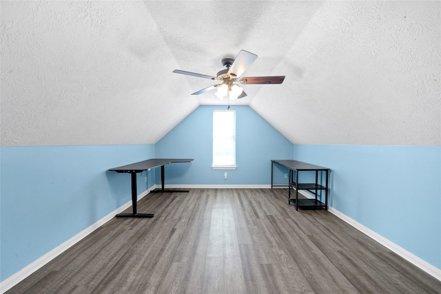 additional living space featuring ceiling fan, lofted ceiling, hardwood / wood-style floors, and a textured ceiling