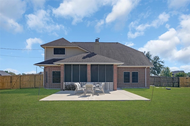 back of property featuring a sunroom, a yard, and a patio area