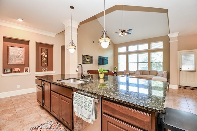 kitchen featuring dark stone counters, a sink, dishwasher, crown molding, and open floor plan