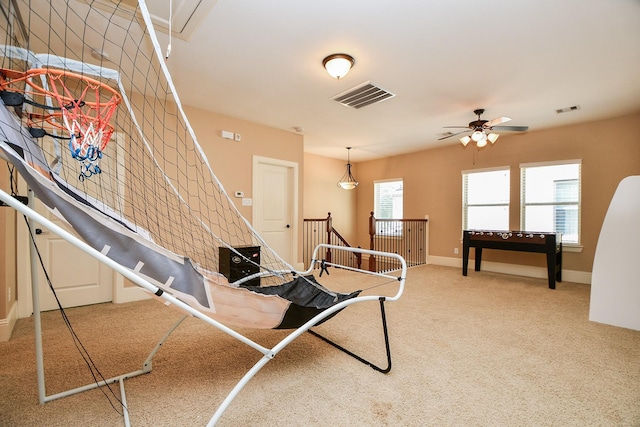 interior space featuring visible vents, carpet flooring, and plenty of natural light