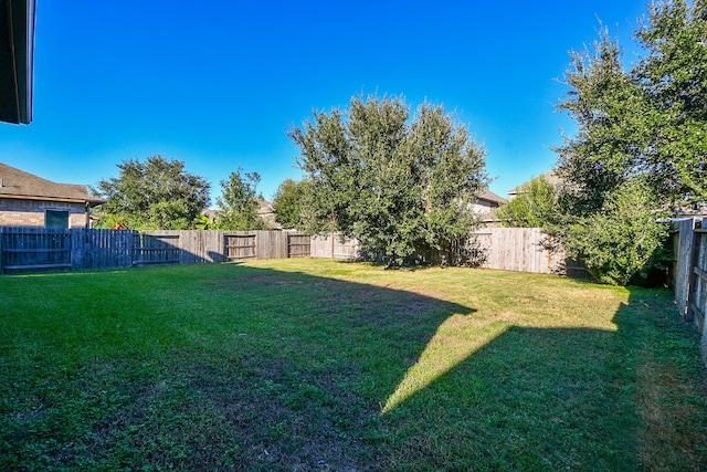 view of yard with a fenced backyard