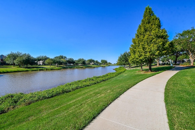 exterior space featuring a yard and a water view