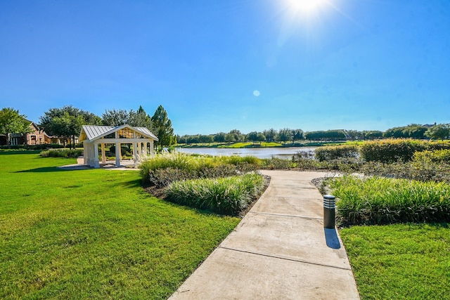 surrounding community with a gazebo, a yard, and a water view