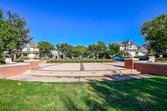 view of home's community featuring a residential view and a lawn