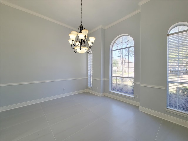 spare room featuring tile patterned floors, ornamental molding, and a notable chandelier