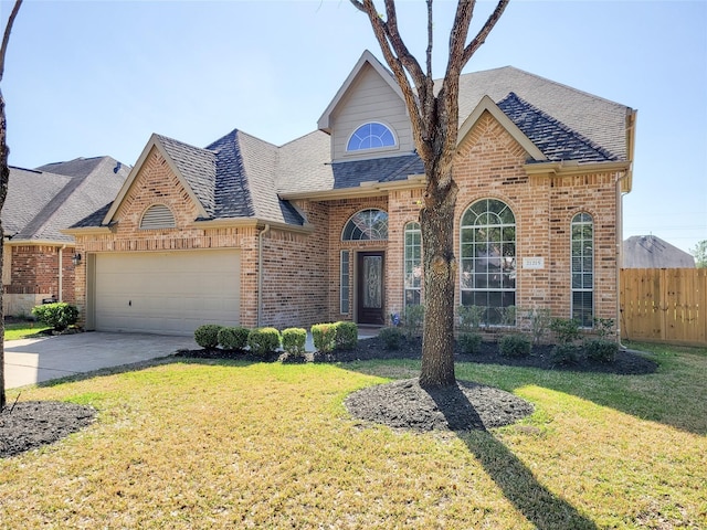 view of front of home featuring a front lawn, brick siding, fence, and an attached garage