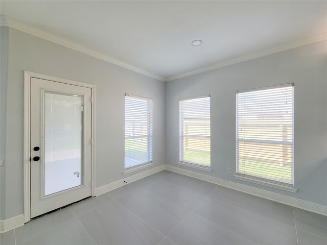 empty room with crown molding and light tile patterned floors