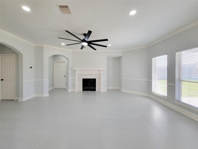 unfurnished living room featuring ceiling fan, ornamental molding, and light tile patterned flooring