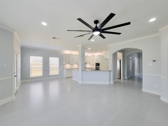 unfurnished living room featuring ornamental molding, light tile patterned flooring, and ceiling fan