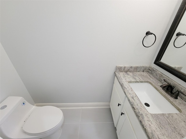 bathroom featuring vanity, tile patterned flooring, and toilet