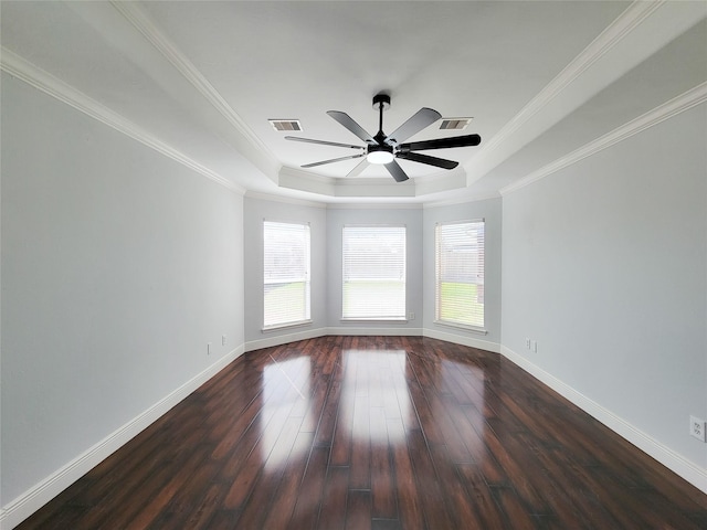 unfurnished room featuring a raised ceiling, crown molding, dark wood-type flooring, and ceiling fan