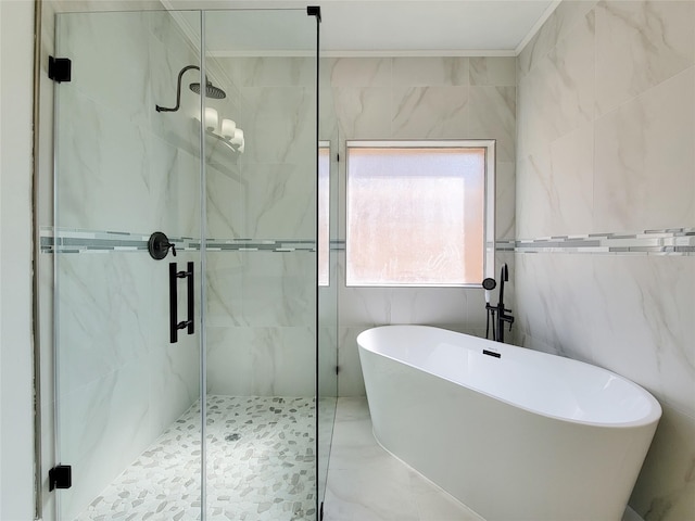 bathroom featuring plus walk in shower and tile walls