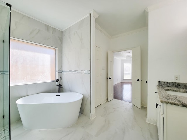 bathroom with crown molding, a bathtub, and vanity