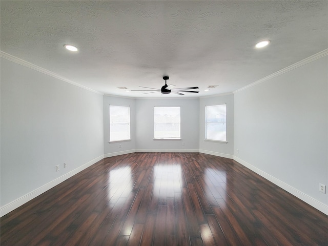 empty room featuring dark hardwood / wood-style flooring, ceiling fan, ornamental molding, and a textured ceiling