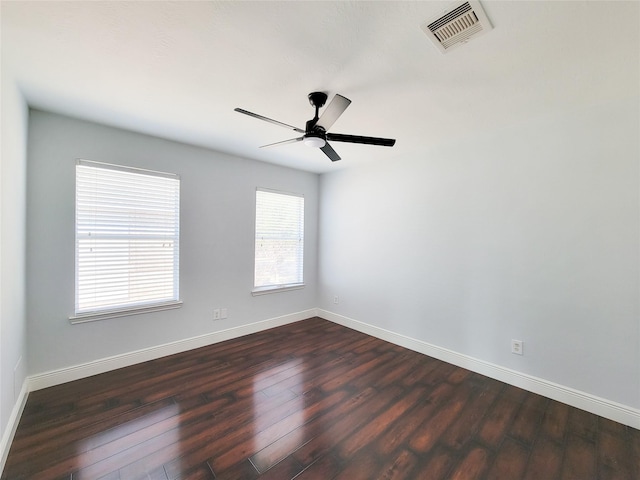 spare room with ceiling fan and dark hardwood / wood-style flooring