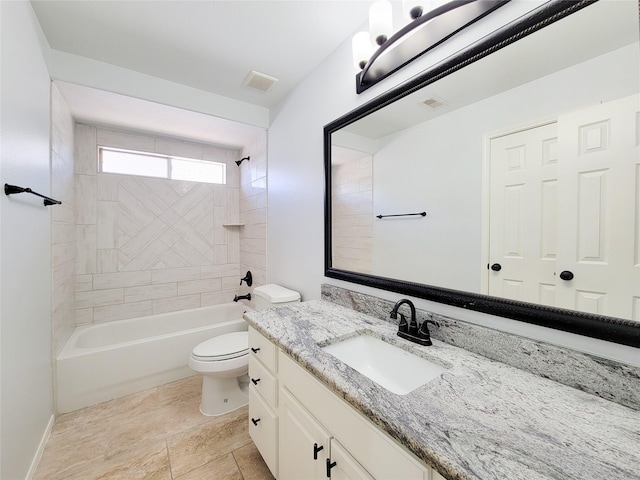 full bathroom with toilet, vanity, and tiled shower / bath