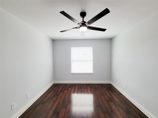 empty room with ceiling fan and dark hardwood / wood-style floors