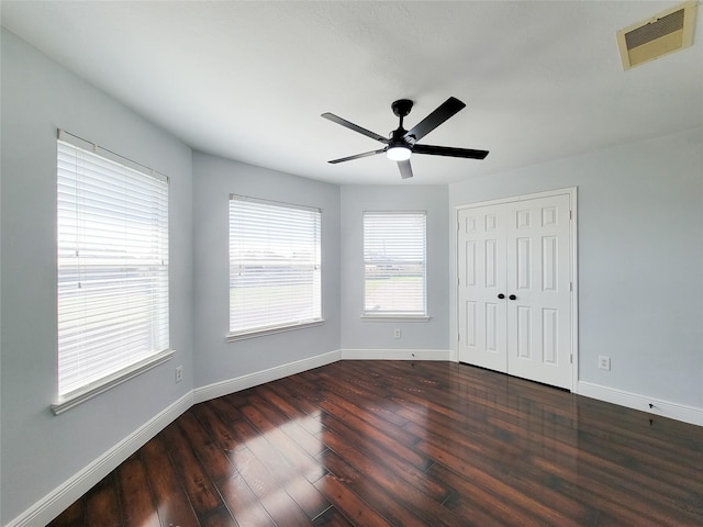 spare room featuring dark hardwood / wood-style floors and ceiling fan