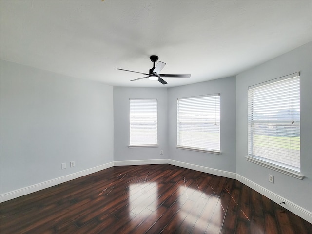 empty room featuring ceiling fan and dark hardwood / wood-style floors