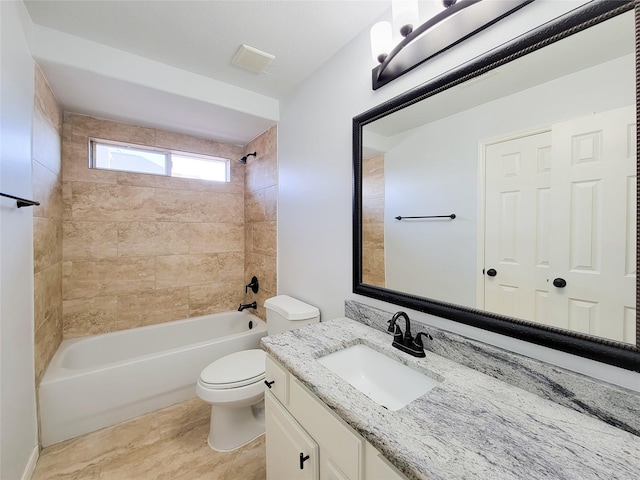 full bathroom with toilet, vanity, and tiled shower / bath