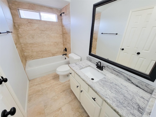 full bathroom with toilet, vanity, and tiled shower / bath