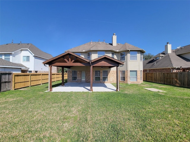 rear view of house with a patio area and a lawn