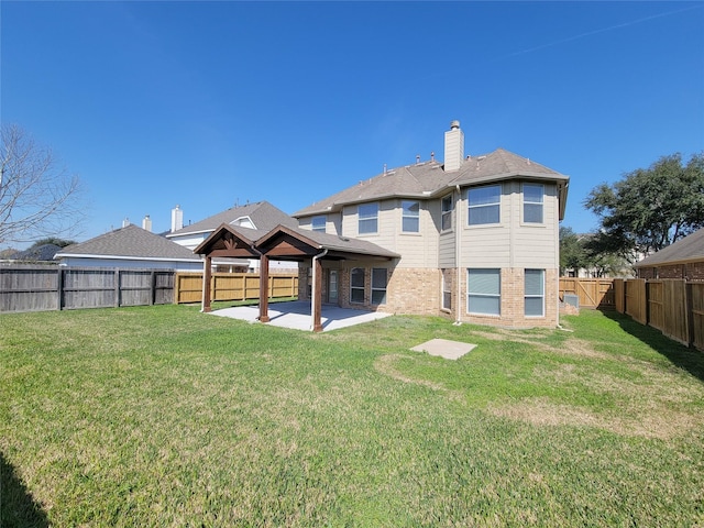 back of house with a patio area, a lawn, and a gazebo