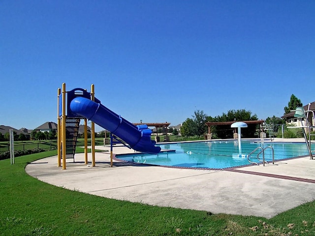 view of pool featuring a yard, a playground, and a water slide