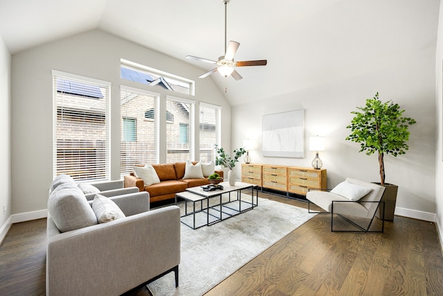 living room with ceiling fan, baseboards, and wood finished floors