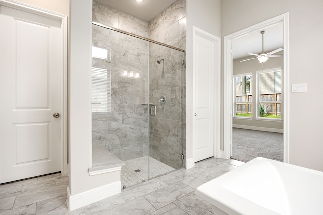 bathroom featuring marble finish floor, a stall shower, a ceiling fan, and baseboards