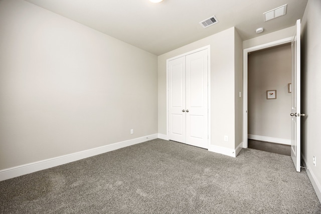 unfurnished bedroom featuring carpet, visible vents, and baseboards