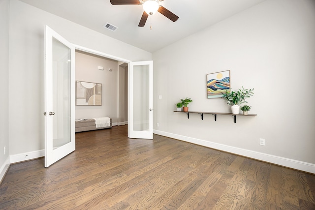 unfurnished bedroom featuring french doors, dark wood finished floors, visible vents, a ceiling fan, and baseboards